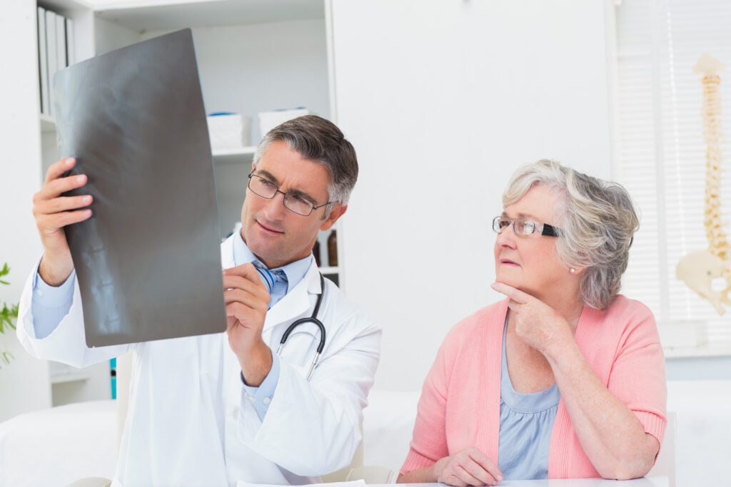 Doctor explaining x ray female patient Doctor explaining x ray female patient