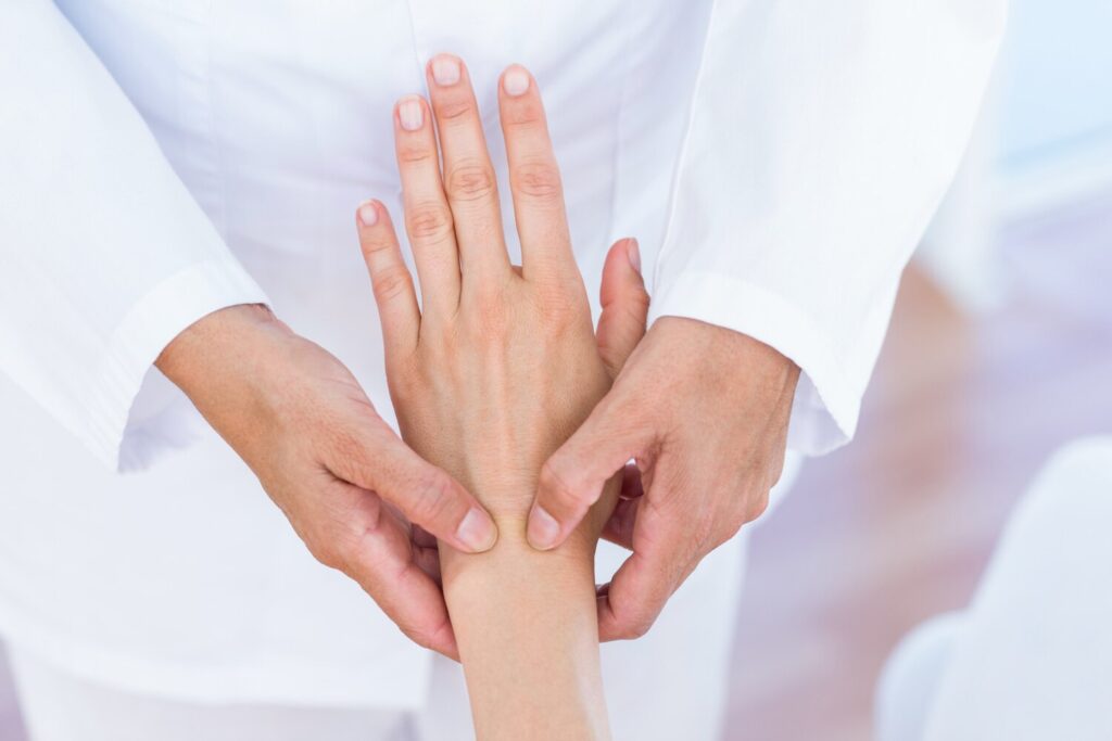Doctor examining her patients wrist 13339 285835 Doctor examining her patients wrist 13339 285835