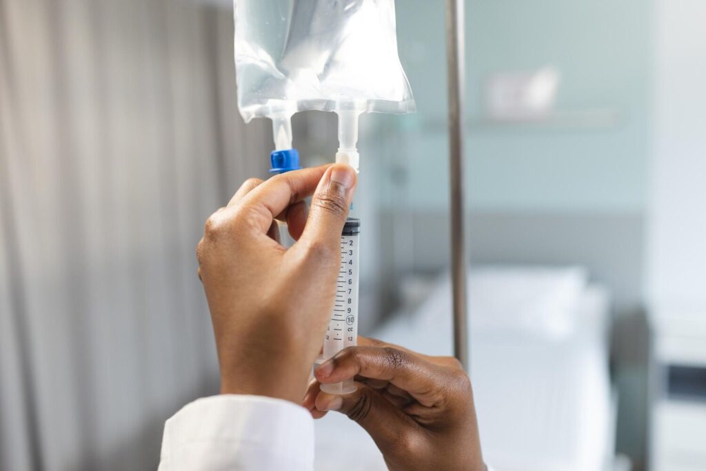 Hands african american female doctor applying drip hospital room 13339 355504 Hands african american female doctor applying drip hospital room 13339 355504
