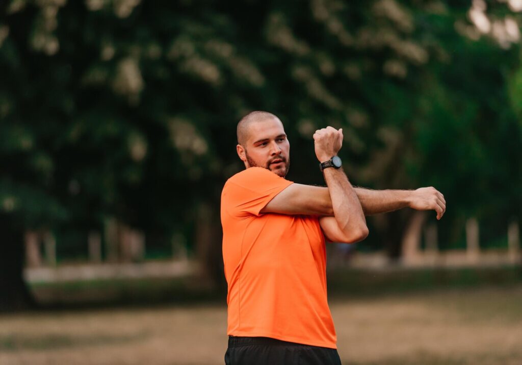 Happy positive sportsman outdoor workout man wearing sports outfit warming up musclesenjoying active lifestyle outside park 597987 3115 Happy positive sportsman outdoor workout man wearing sports outfit warming up musclesenjoying active lifestyle outside park 597987 3115