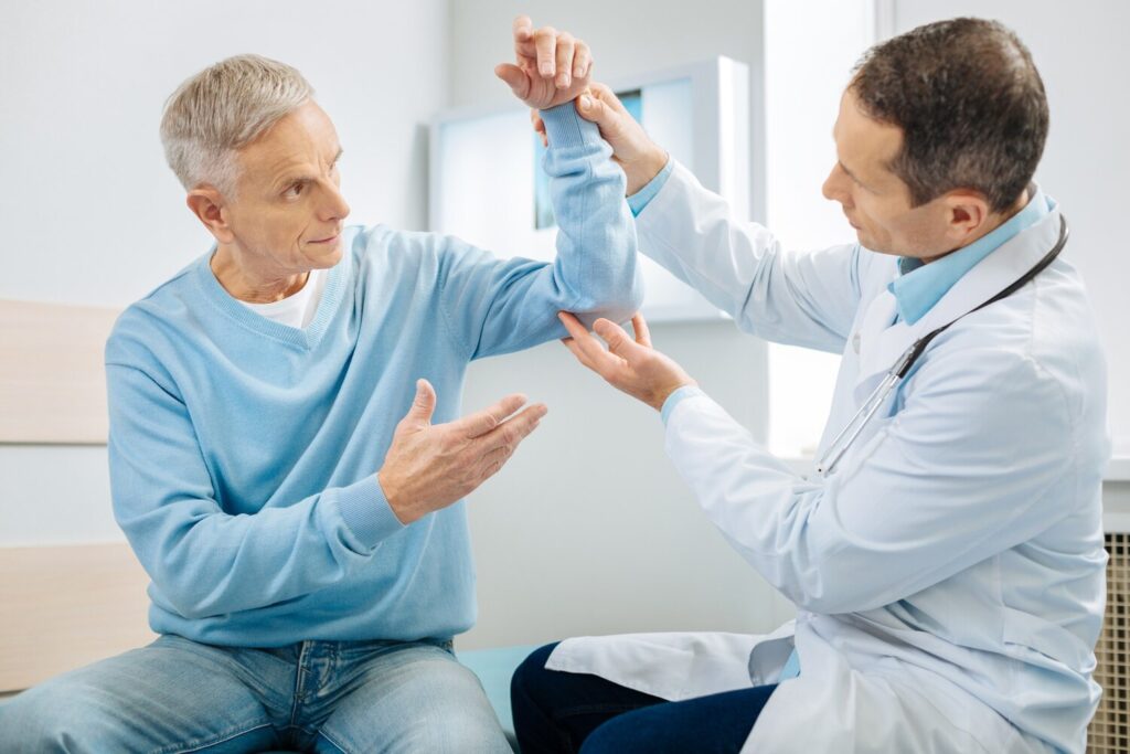 What is with me concerned anxious aged man holding his hand up looking doctor while worrying about his health 259150 23192 What is with me concerned anxious aged man holding his hand up looking doctor while worrying about his health 259150 23192
